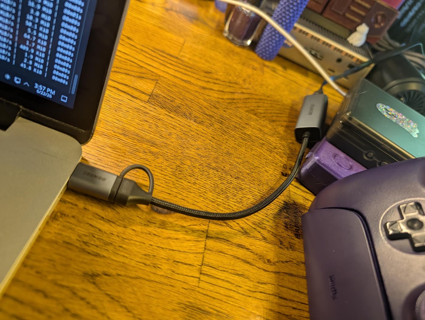 A Benfei USB-ethernet adapter connecting an ethernet cable to an old MacBook Pro